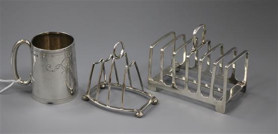 Two silver toastracks (one a.f.) and a silver christening mug.